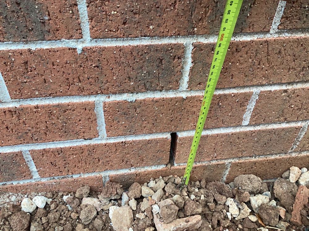 Surface built up close to the weep holes, cutting the required clearance, found during a pre-handover inspection in Werribee