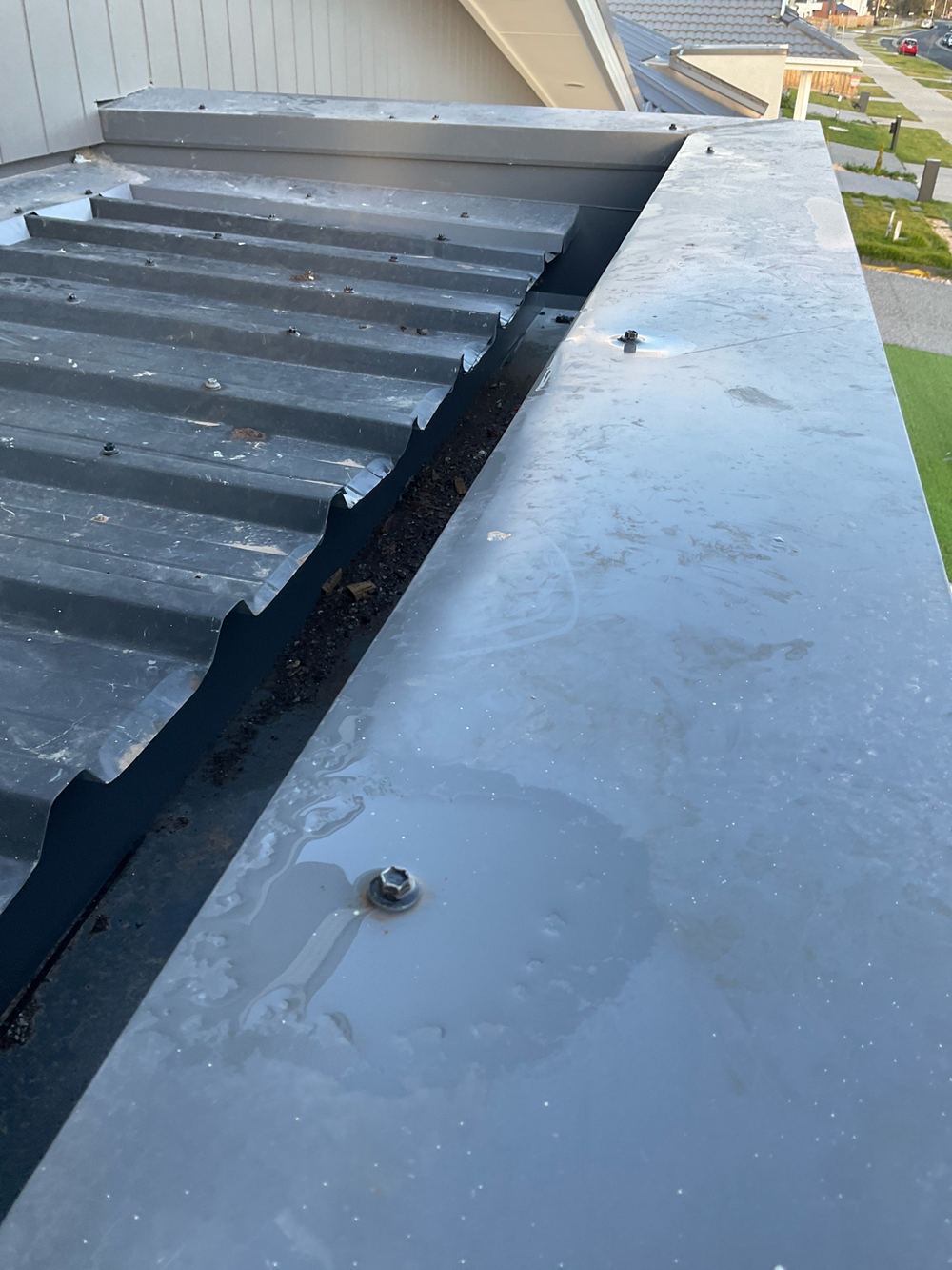 Water ponding on wall cappings, which corrodes them and leaks at fixings, Werribee