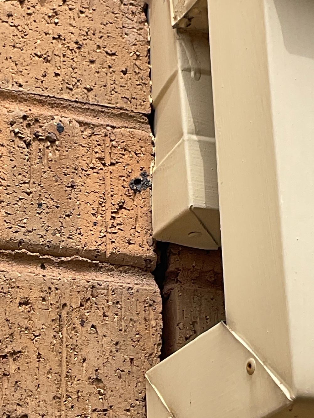 Open gaps in the brick veneer letting in moisture and pests, found during a building and pest inspection in Sunshine North