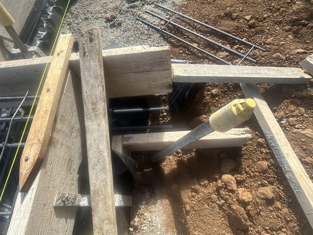Vapour barrier stopping short of the beam bases, leaving a path for ground moisture, found during a slab pre-pour inspection in Werribee