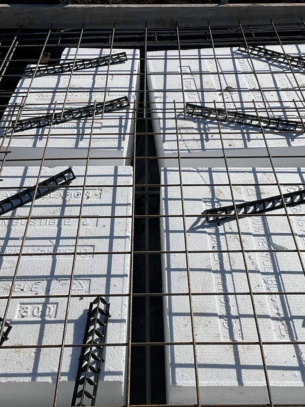 Internal beam squeezed below its 110mm minimum where the trench was obstructed, found during a slab pre-pour inspection in Werribee