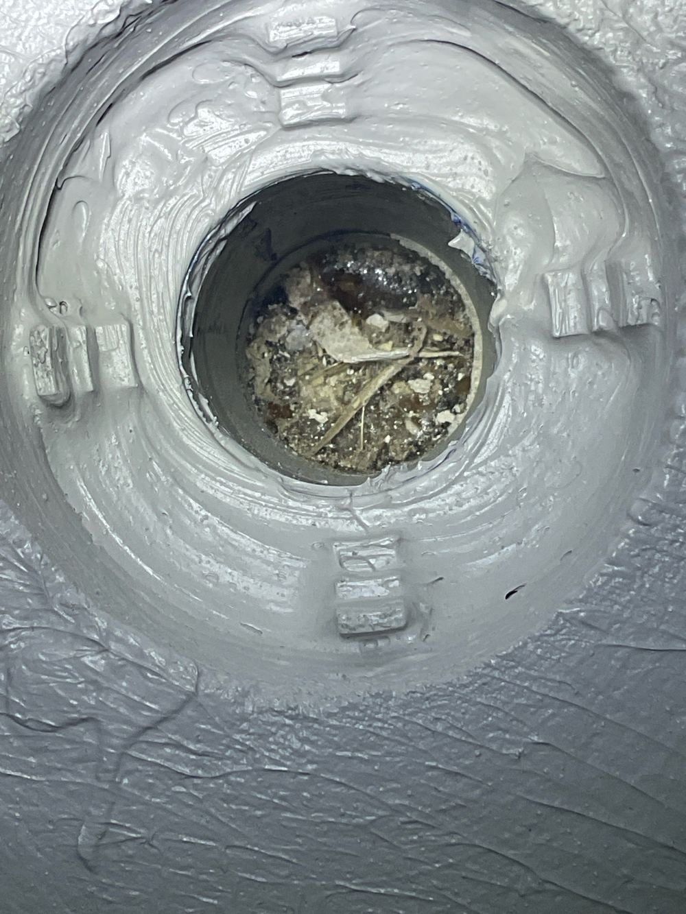 Shower waste clogged with building debris that could block it later, found during a waterproofing inspection in Werribee